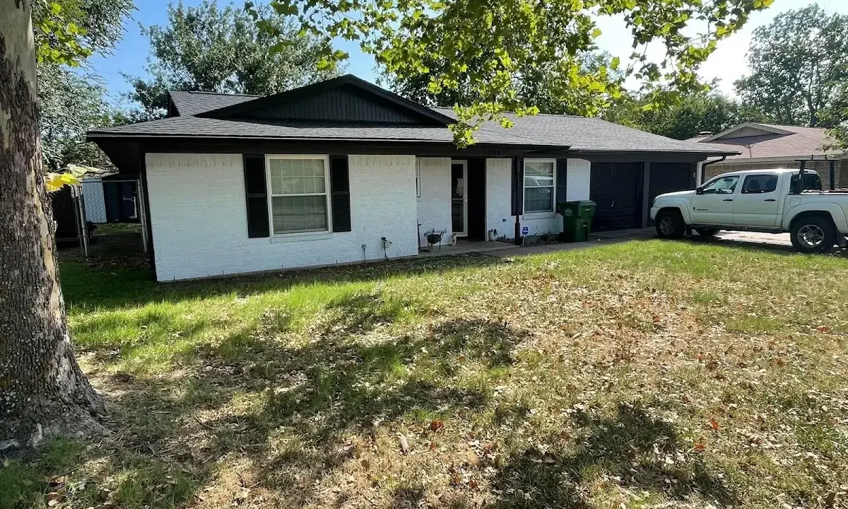 Professional roofing crew working on a residential roof in Stowe